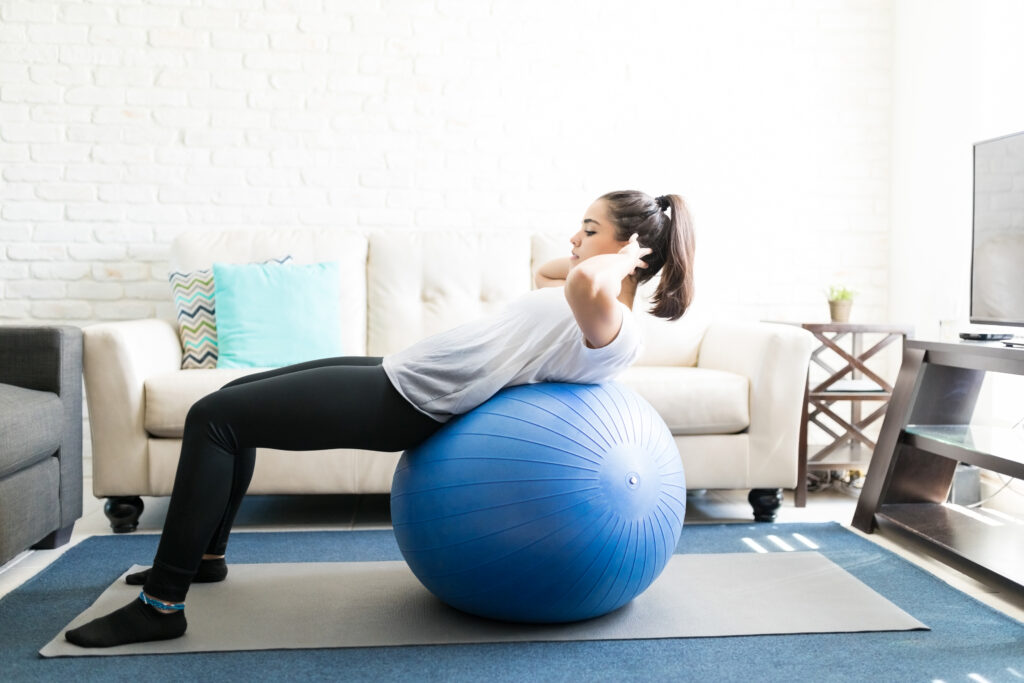 Woman on swiss ball doing abs exercise